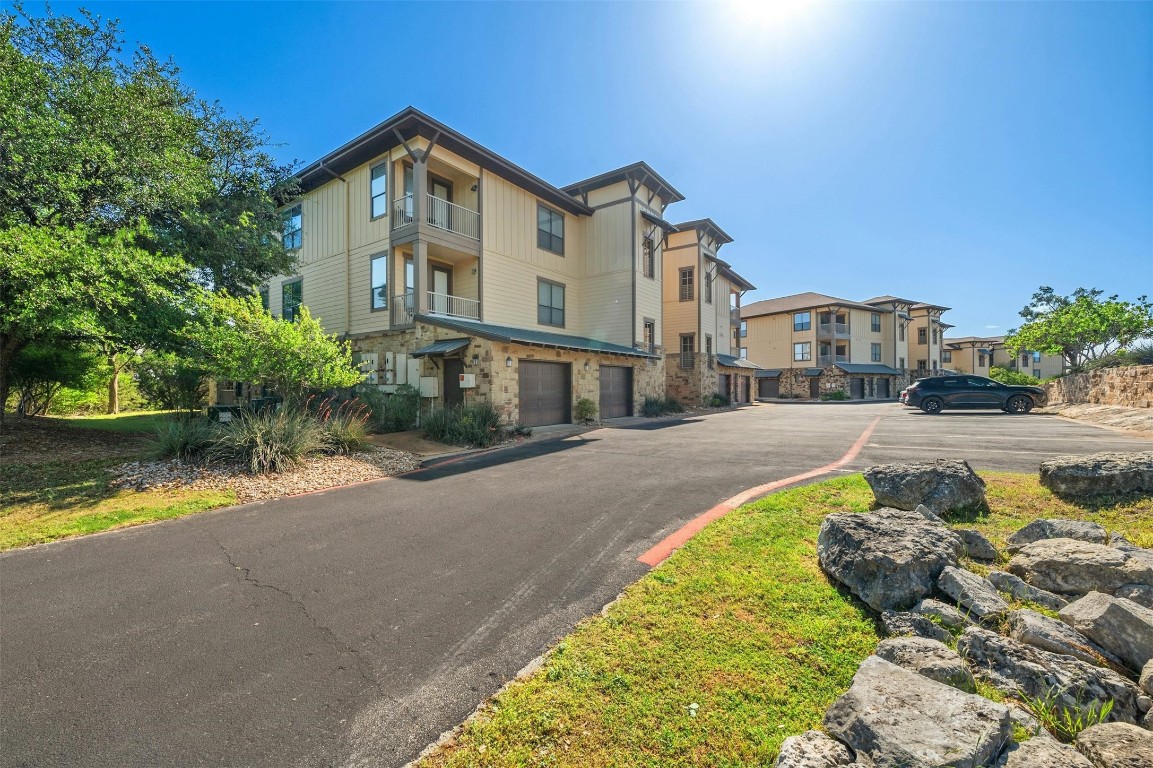 17800 Edgewood Way, Unit 202 Jonestown, TX 78645 - Photo 2 of 40 a front view of a house with a yard