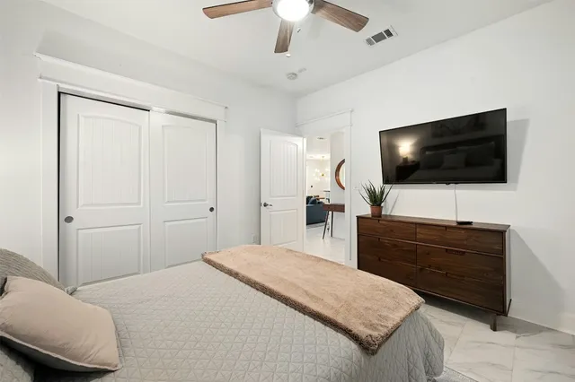 a bedroom with a bed and a flat screen tv