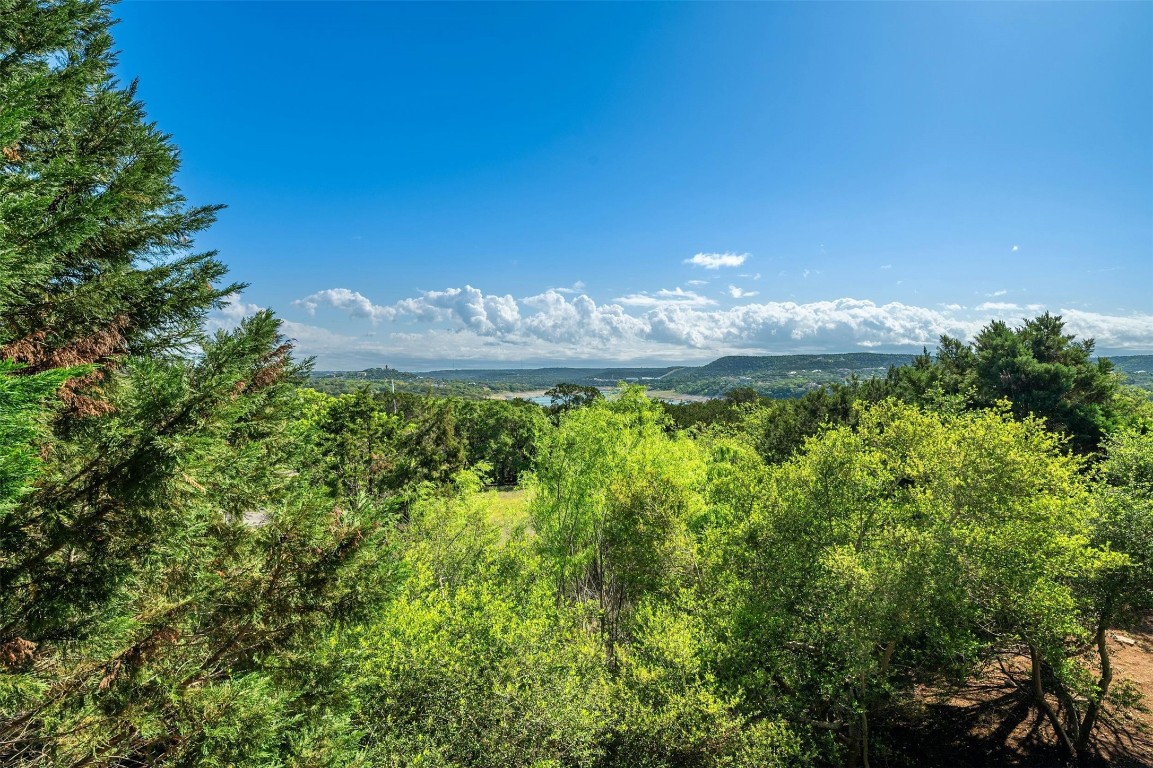 17800 Edgewood Way, Unit 202 Jonestown, TX 78645 - Photo 26 of 40 a view of a lake with a yard