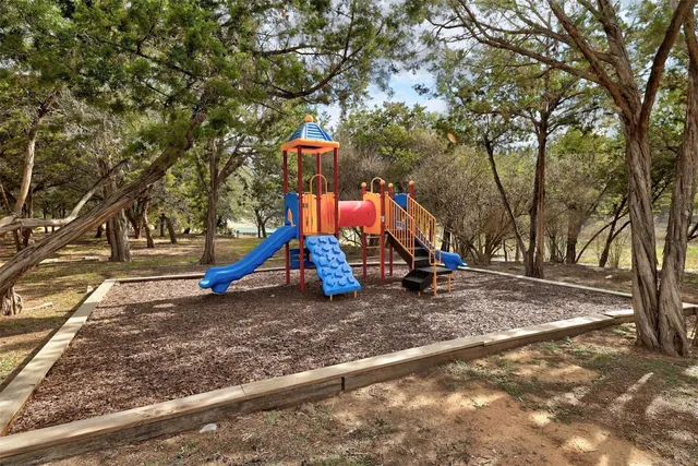 a view of outdoor space with playground and green space