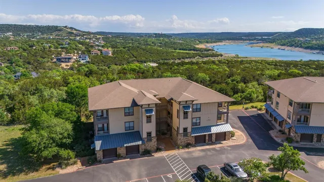 an aerial view of a house with a garden and lake view