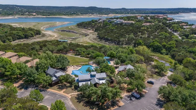 an aerial view of lake and residential houses with outdoor space