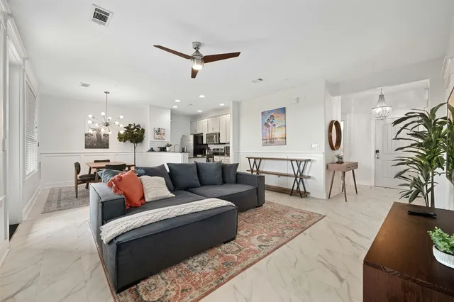 a living room with furniture and kitchen view