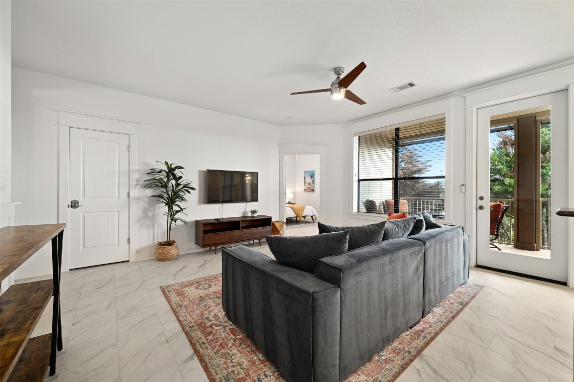 17800 Edgewood Way, Unit 202 Jonestown, TX 78645 - Photo 8 of 40 a living room with furniture and a flat screen tv