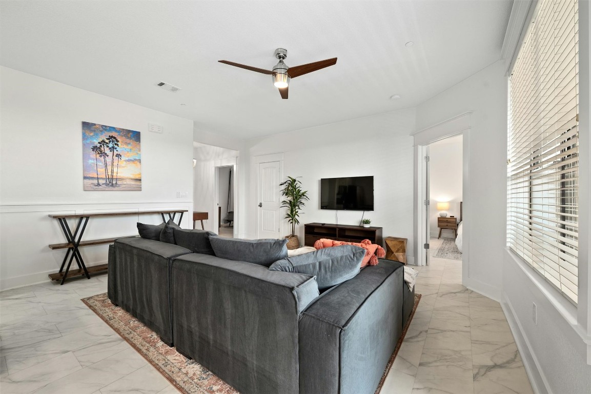 17800 Edgewood Way, Unit 202 Jonestown, TX 78645 - Photo 9 of 40 a living room with furniture and a flat screen tv
