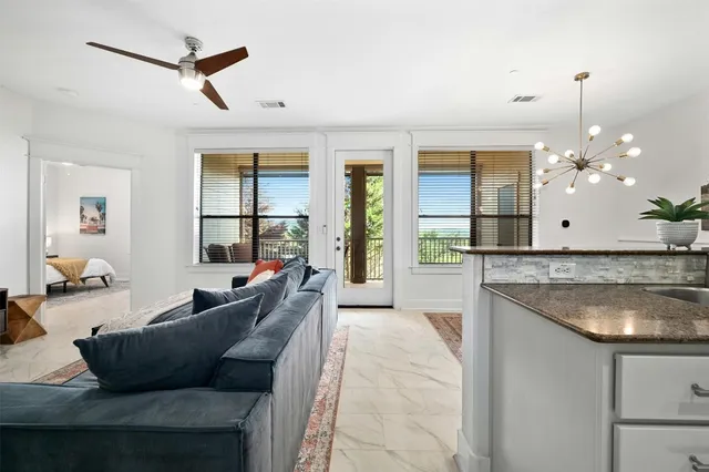a living room with furniture and a chandelier