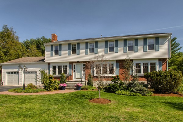 4 Snowberry Road Andover, MA 01810 - Photo 1 of 30 a front view of a house with a yard table and chairs