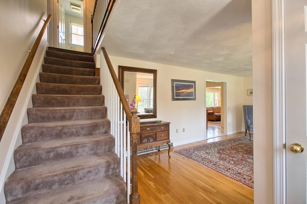 4 Snowberry Road Andover, MA 01810 - Photo 13 of 30 a view of an entryway with wooden floor and a livingroom