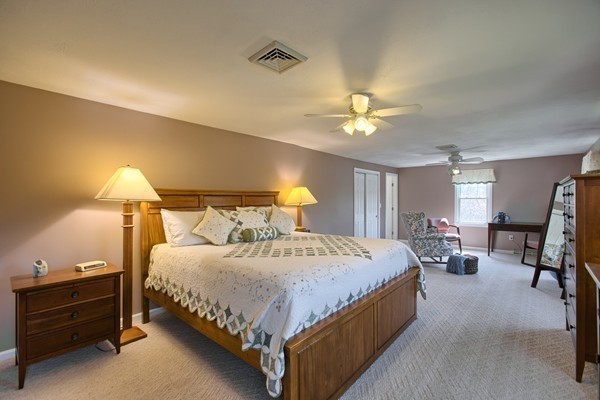 4 Snowberry Road Andover, MA 01810 - Photo 14 of 30 a bedroom with a bed and a chandelier