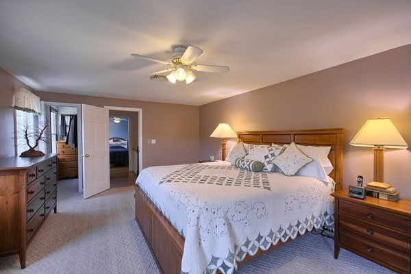 4 Snowberry Road Andover, MA 01810 - Photo 15 of 30 a bedroom with a bed and a chandelier