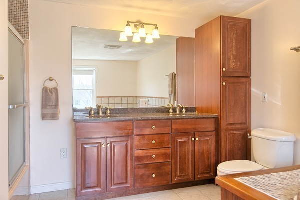 4 Snowberry Road Andover, MA 01810 - Photo 17 of 30 a bathroom with a granite countertop sink a toilet and a mirror