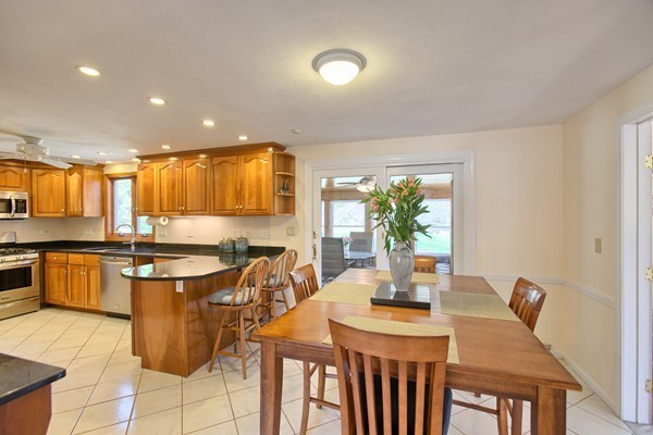4 Snowberry Road Andover, MA 01810 - Photo 3 of 30 a kitchen with a table chairs stove and kitchen island