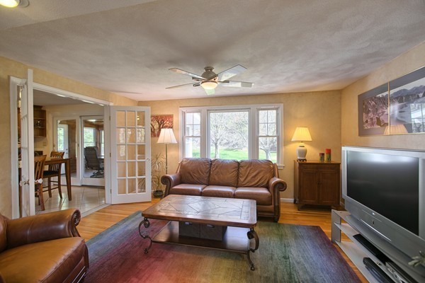 4 Snowberry Road Andover, MA 01810 - Photo 5 of 30 a living room with furniture and a flat screen tv