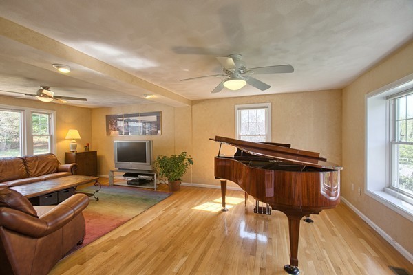 4 Snowberry Road Andover, MA 01810 - Photo 6 of 30 a living room with furniture a fireplace and a flat screen tv