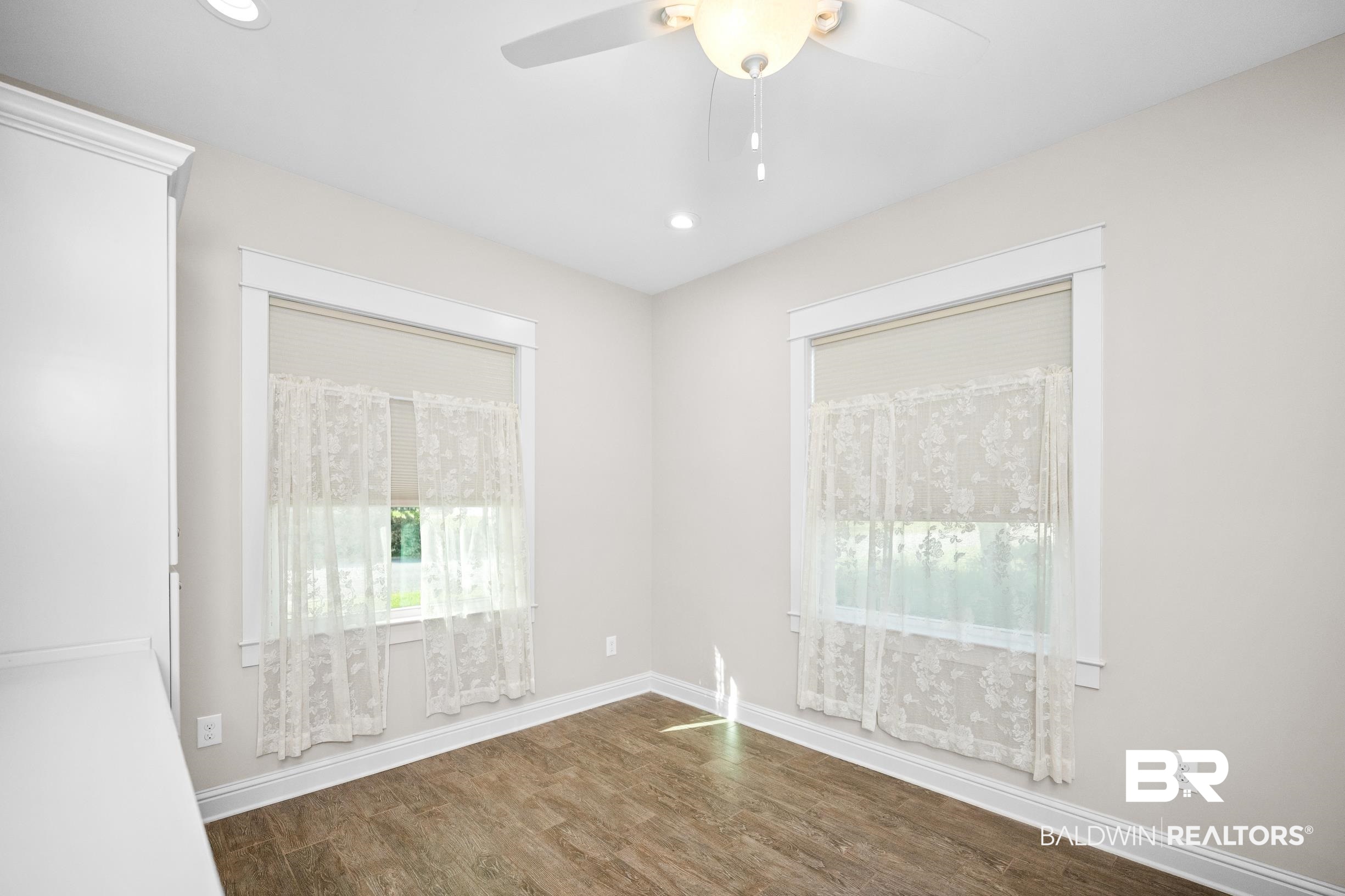 12254 Reunion Place Foley, AL 36535 - Photo 30 of 62 Empty room with a ceiling fan, healthy amount of natural light, wood finished floors, recessed lighting, and baseboards