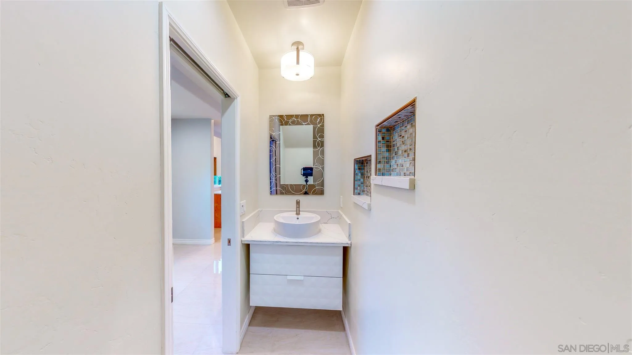 9957 Sierra Madre Road Spring Valley, CA 91977 - Photo 12 of 46 a bathroom with a sink and a mirror