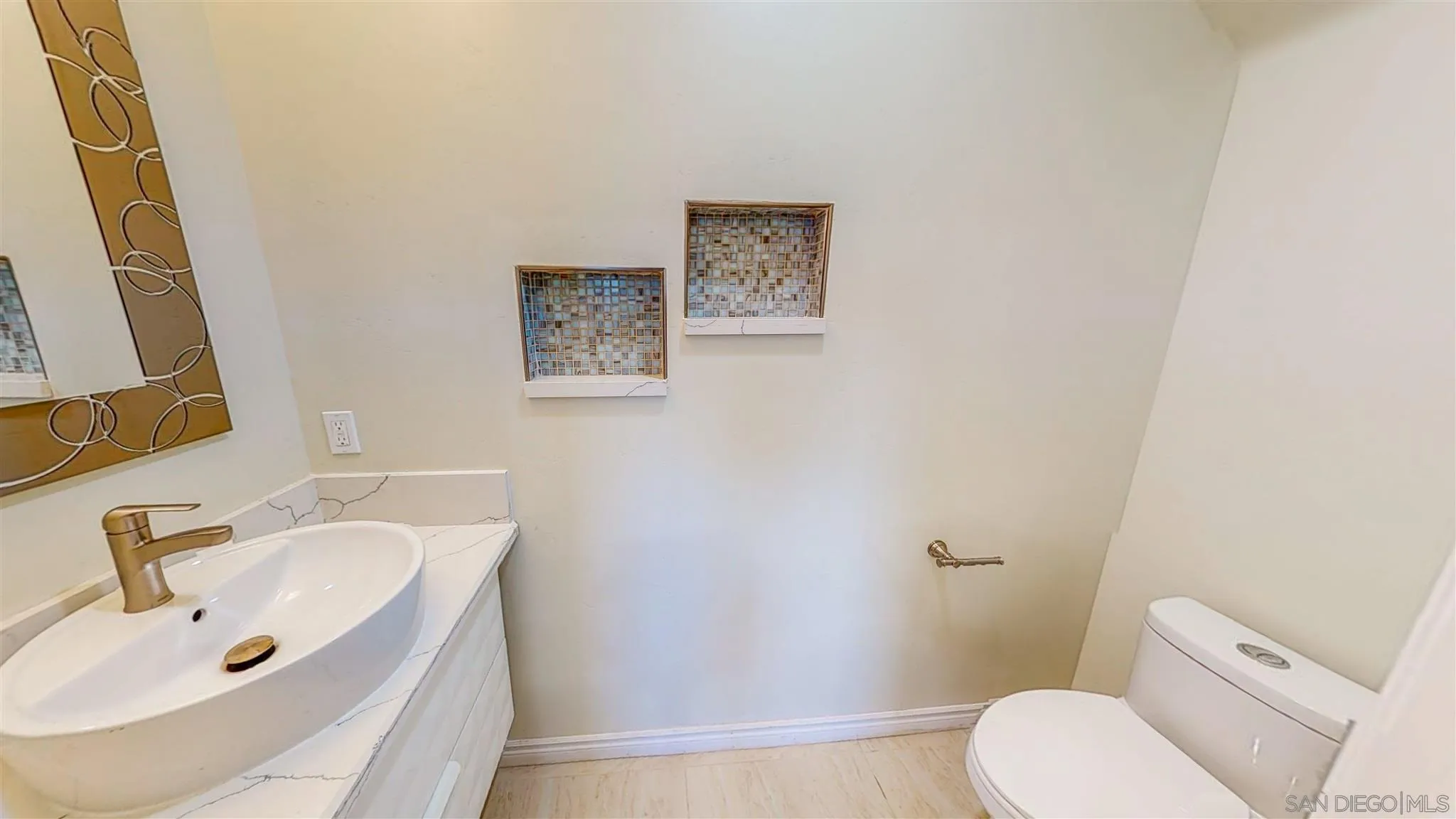 9957 Sierra Madre Road Spring Valley, CA 91977 - Photo 13 of 46 a white toilet sitting next to a bathroom sink