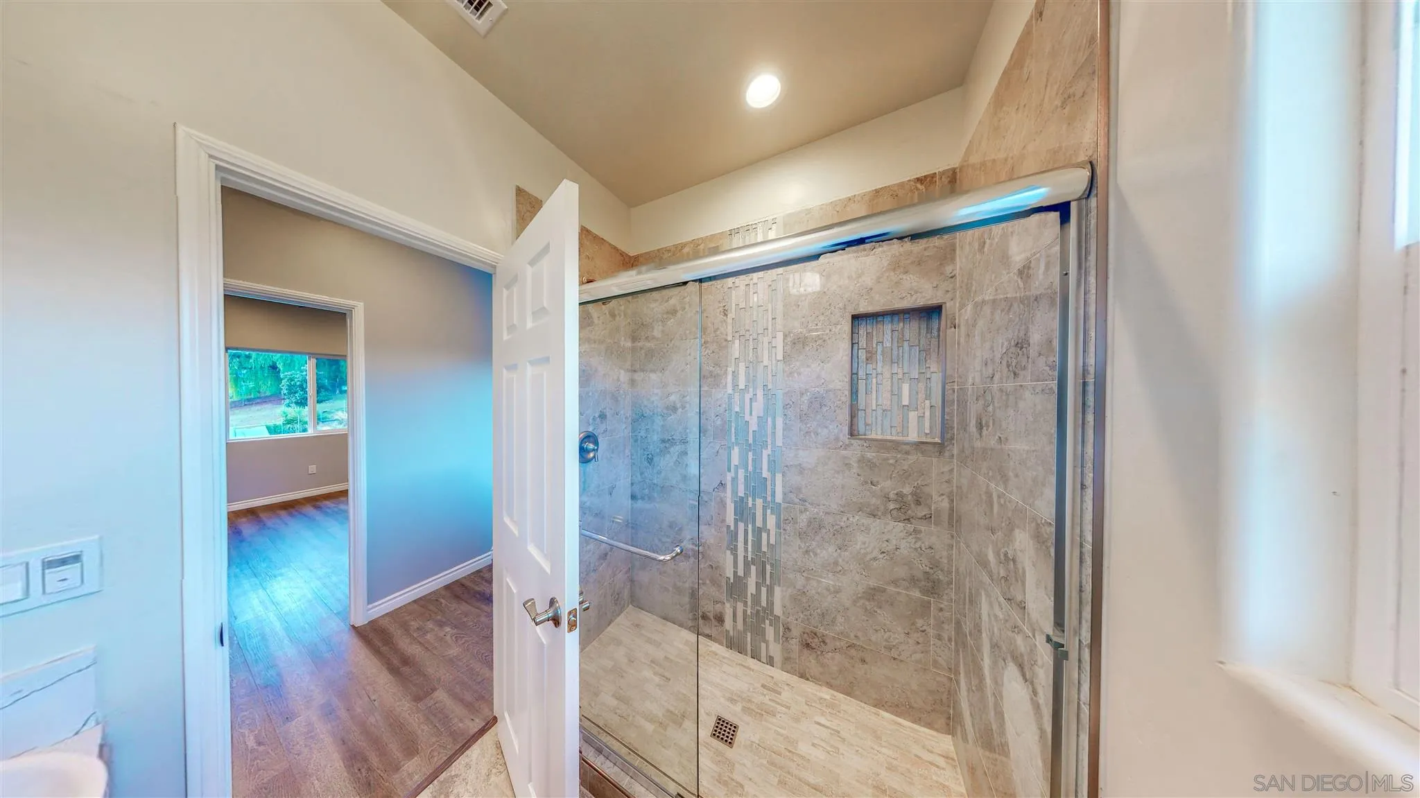 9957 Sierra Madre Road Spring Valley, CA 91977 - Photo 21 of 46 a bathroom with a glass shower door and a sink