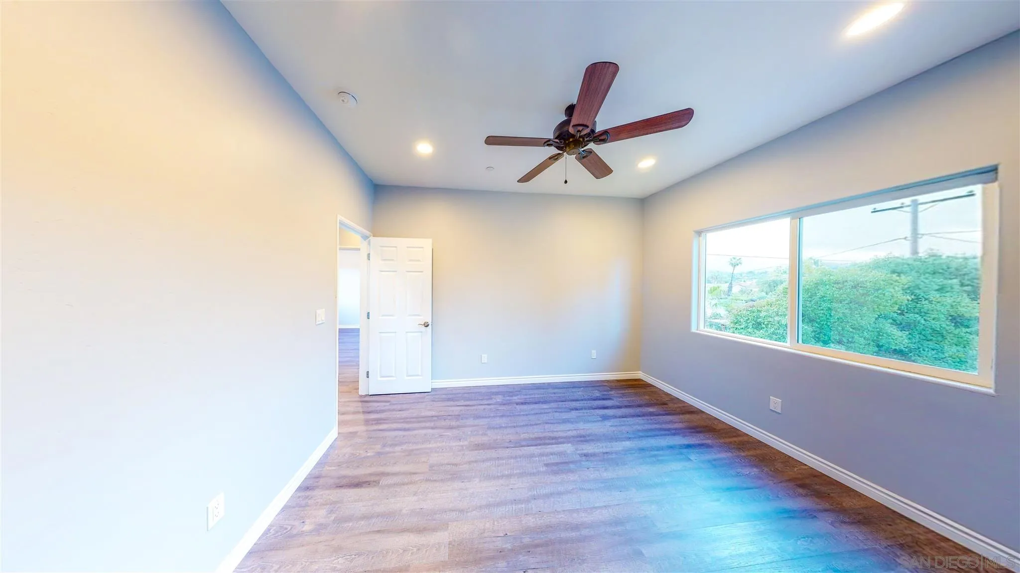 9957 Sierra Madre Road Spring Valley, CA 91977 - Photo 25 of 46 a view of empty room with wooden floor and fan