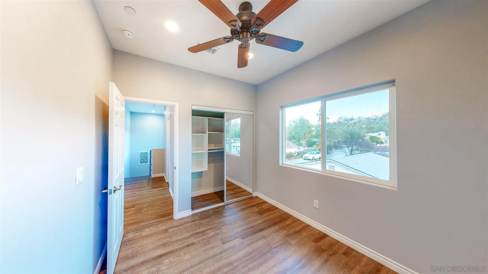9957 Sierra Madre Road Spring Valley, CA 91977 - Photo 27 of 46 a view of empty room with wooden floor and fan