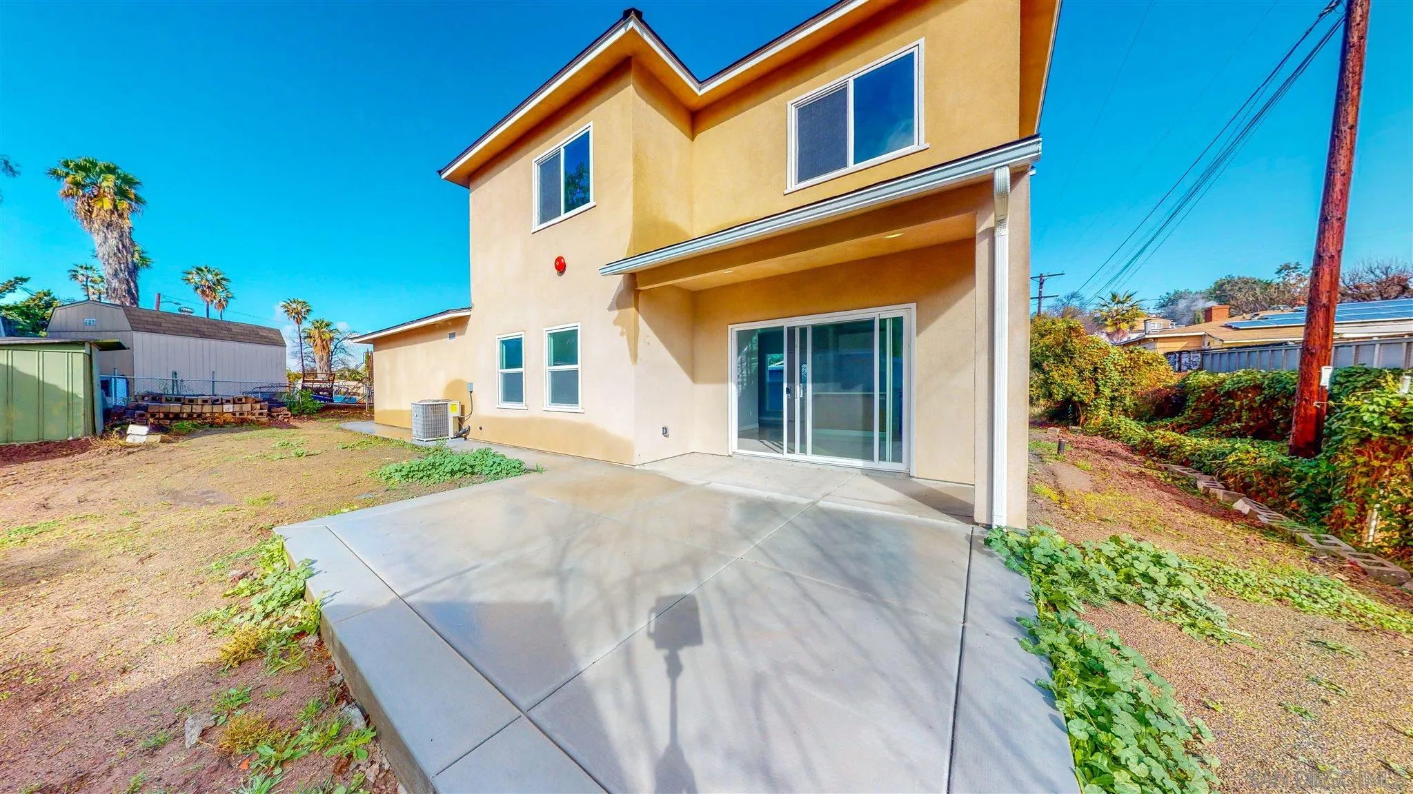 9957 Sierra Madre Road Spring Valley, CA 91977 - Photo 3 of 46 a front view of a house with a yard and potted plants