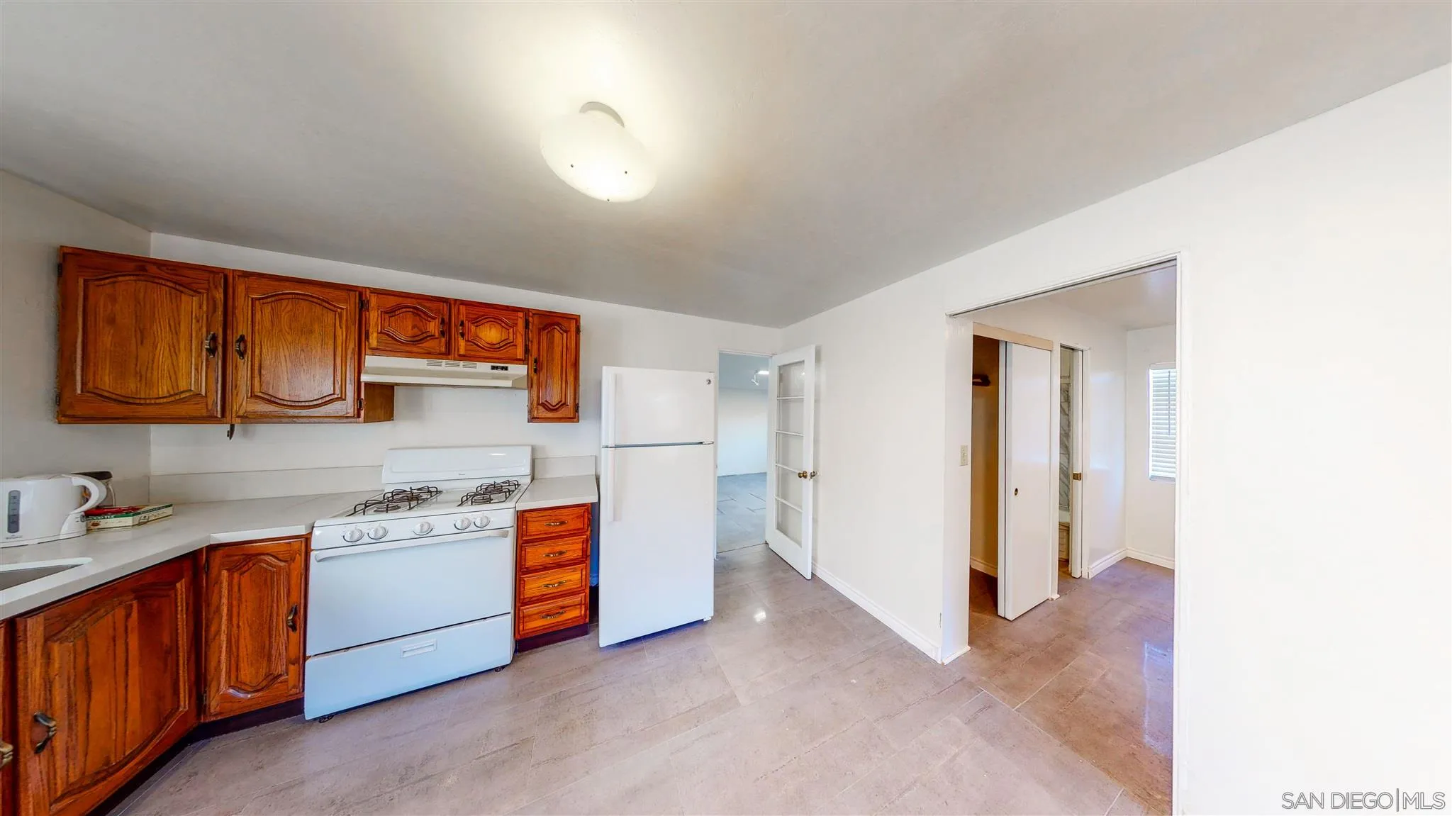 9957 Sierra Madre Road Spring Valley, CA 91977 - Photo 37 of 46 a view of a kitchen with stainless steel appliances granite countertop a sink and cabinets