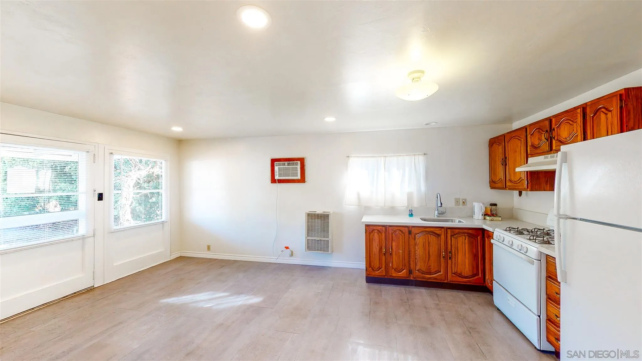 9957 Sierra Madre Road Spring Valley, CA 91977 - Photo 43 of 46 a kitchen with stainless steel appliances granite countertop a refrigerator a sink dishwasher and a stove with wooden floor