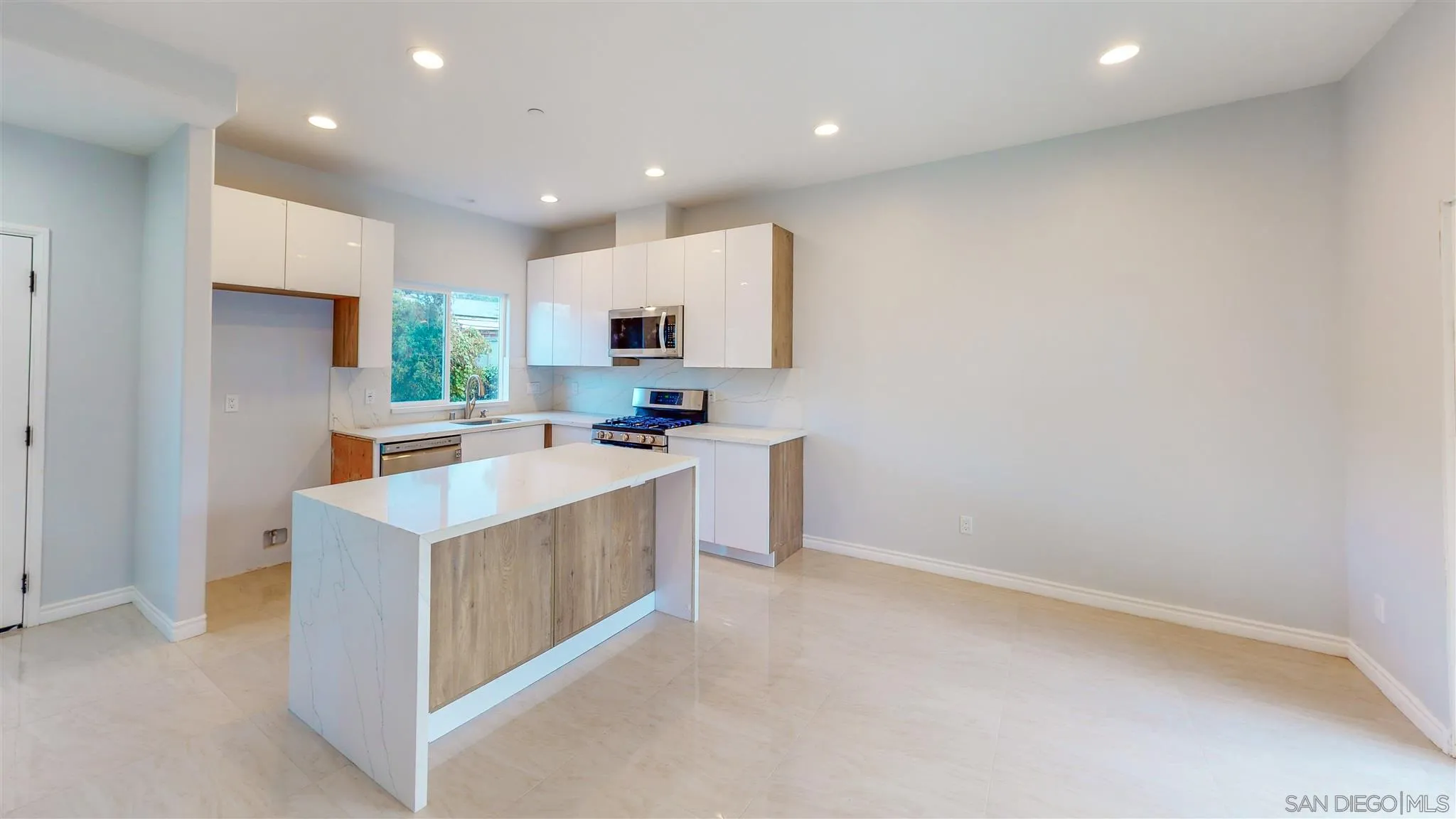 9957 Sierra Madre Road Spring Valley, CA 91977 - Photo 5 of 46 a kitchen with kitchen island microwave and refrigerator