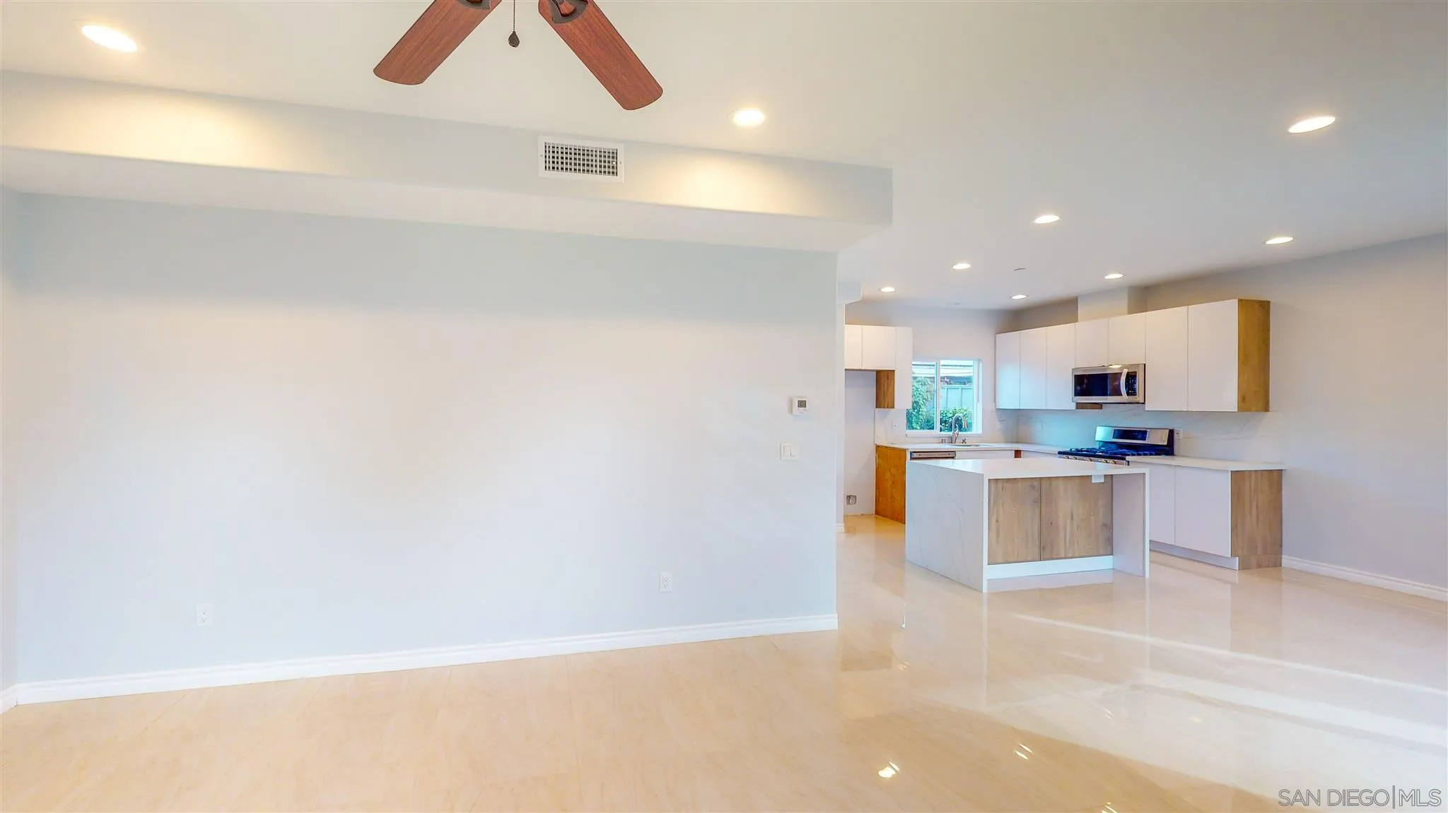 9957 Sierra Madre Road Spring Valley, CA 91977 - Photo 7 of 46 a view of kitchen with kitchen island white cabinets and refrigerator