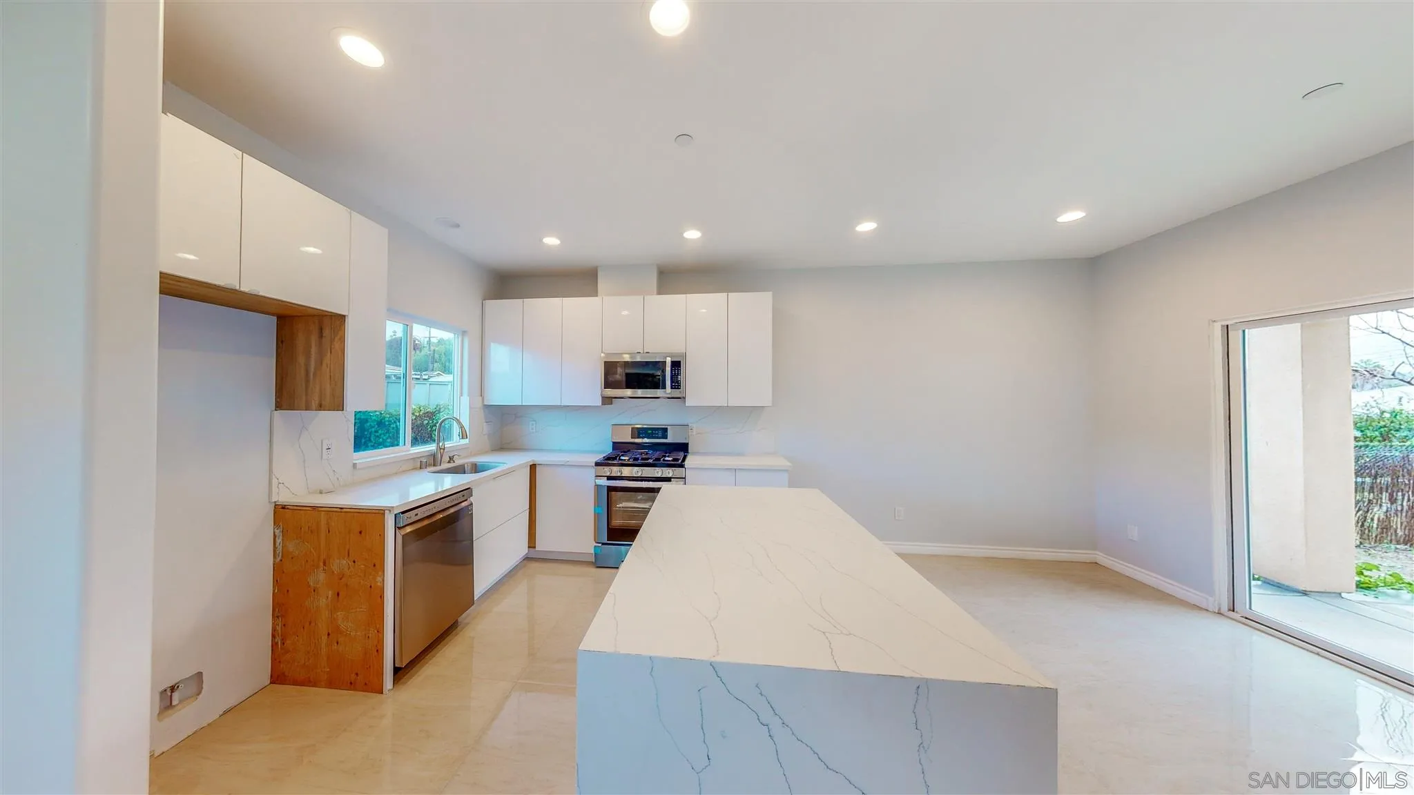 9957 Sierra Madre Road Spring Valley, CA 91977 - Photo 9 of 46 a large kitchen with a large counter top appliances and cabinets