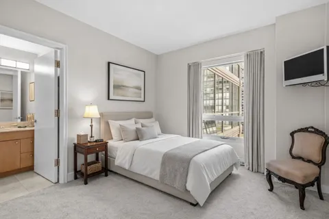 a bedroom with a bed and a television