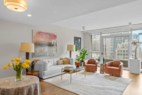 a living room with furniture and a potted plant