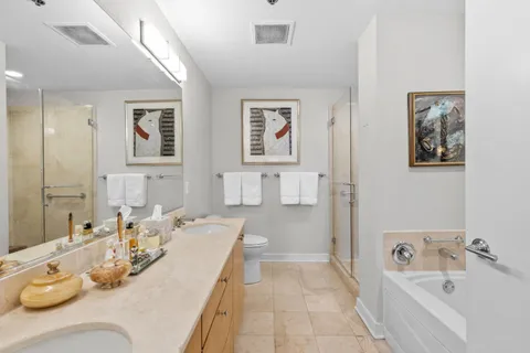 a bathroom with a tub sink and mirror