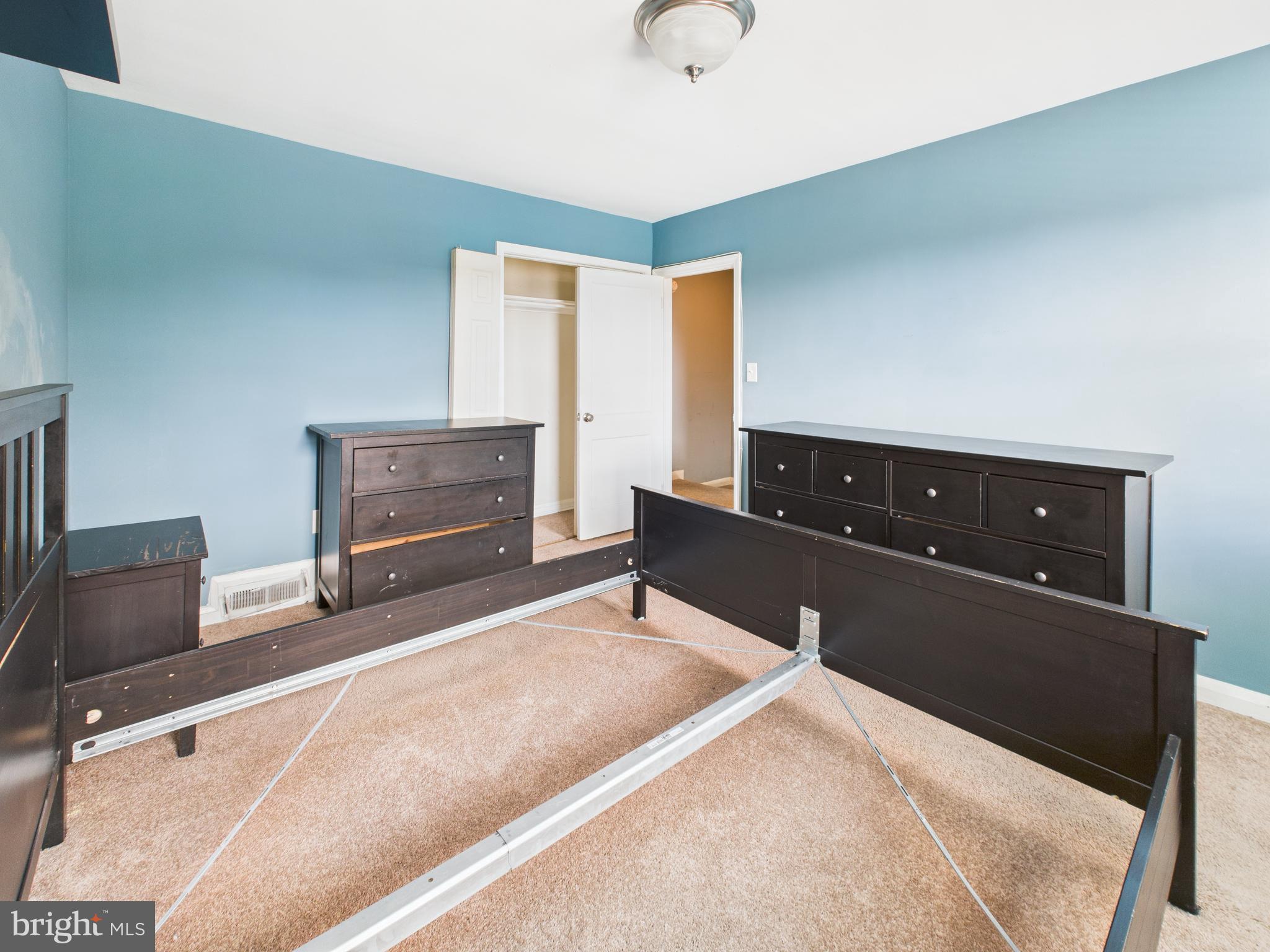 1206 Cedarcroft Road Baltimore, MD 21239 - Photo 15 of 29 a bedroom with furniture and a dresser