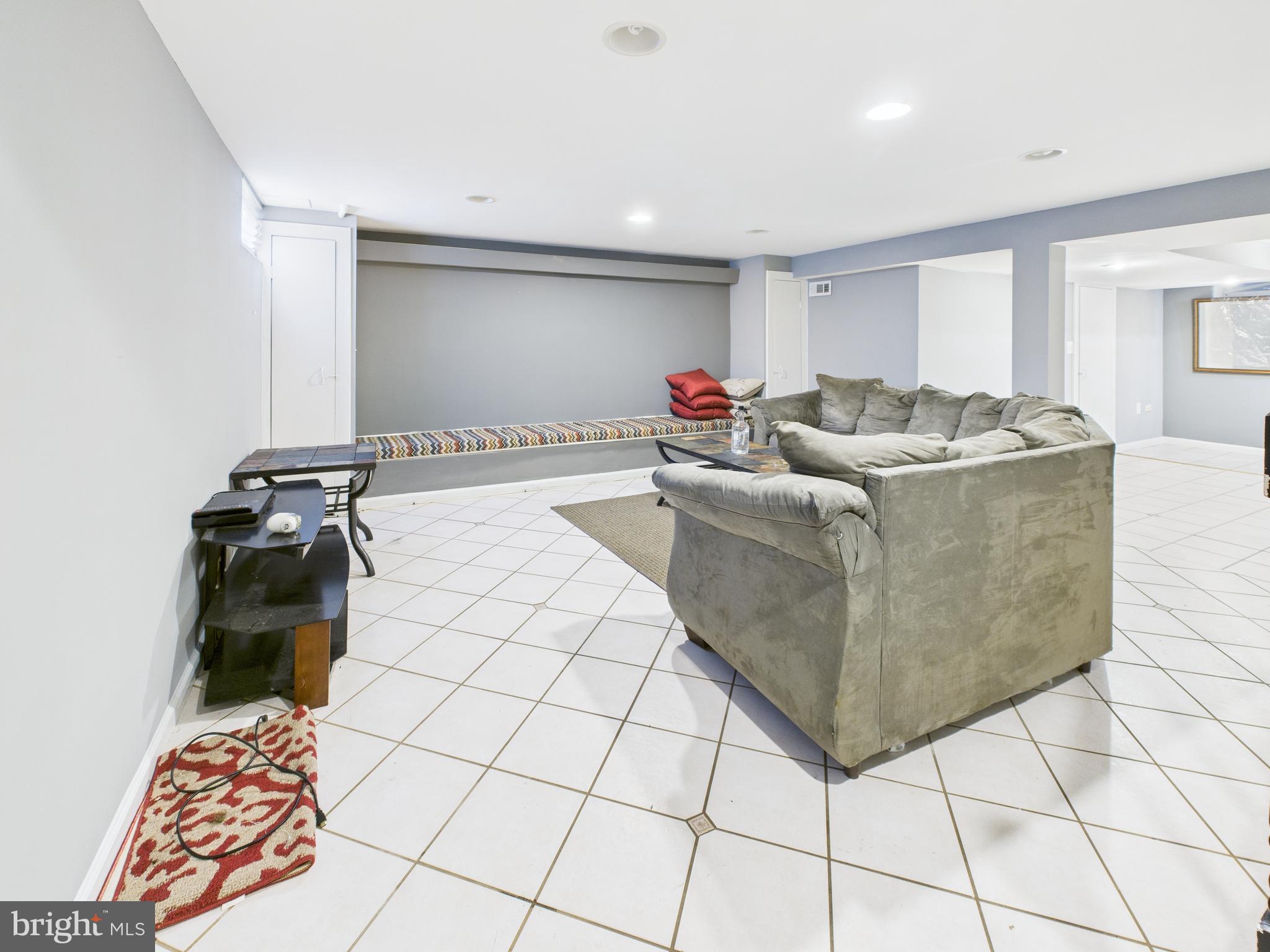 1206 Cedarcroft Road Baltimore, MD 21239 - Photo 18 of 29 a living room with furniture and a rug