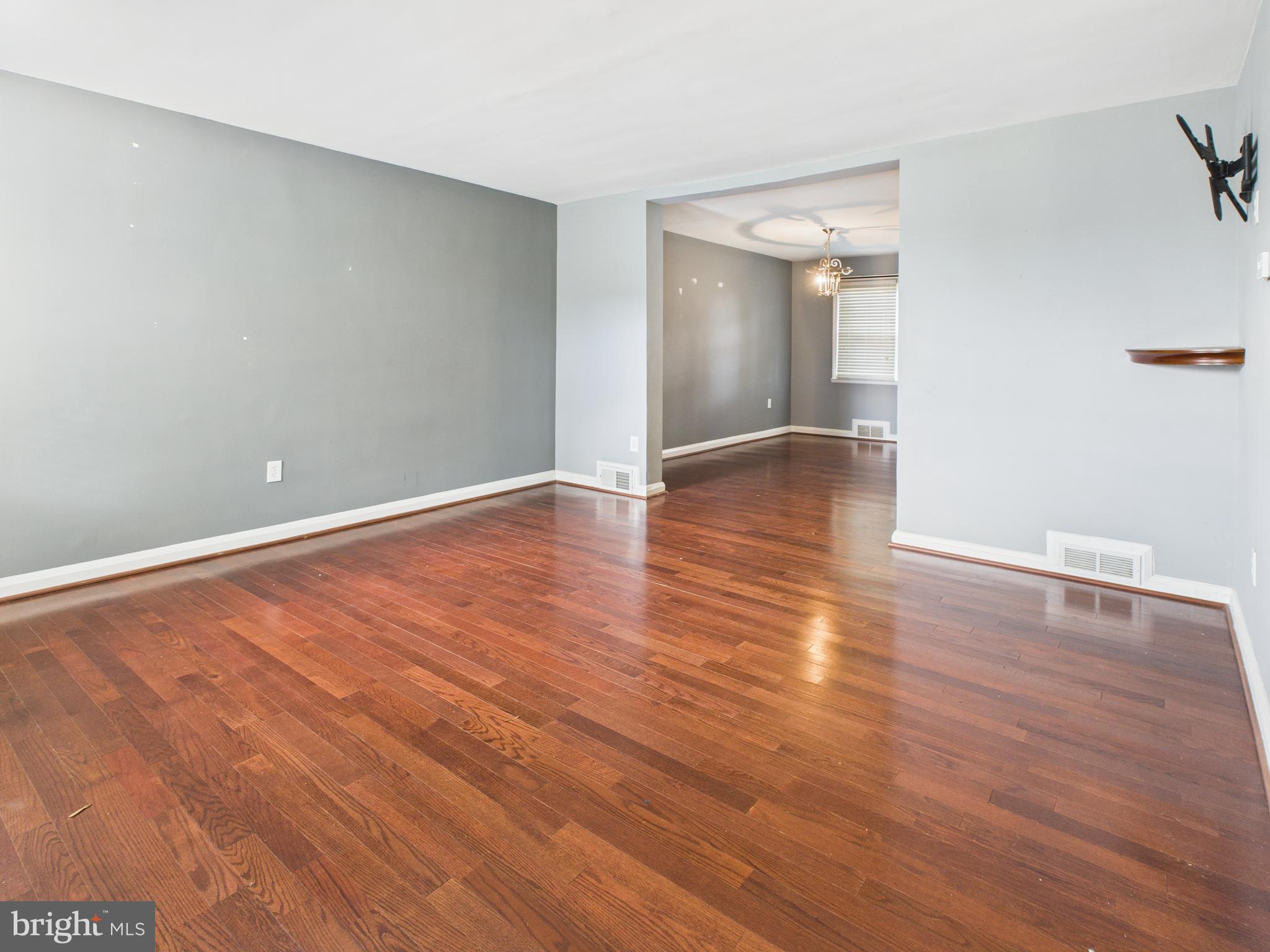 1206 Cedarcroft Road Baltimore, MD 21239 - Photo 2 of 29 a view of an empty room with wooden floor