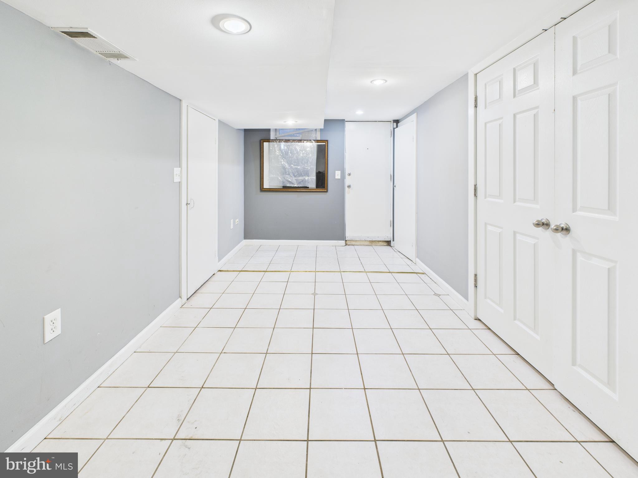 1206 Cedarcroft Road Baltimore, MD 21239 - Photo 22 of 29 a view of an empty room and windows