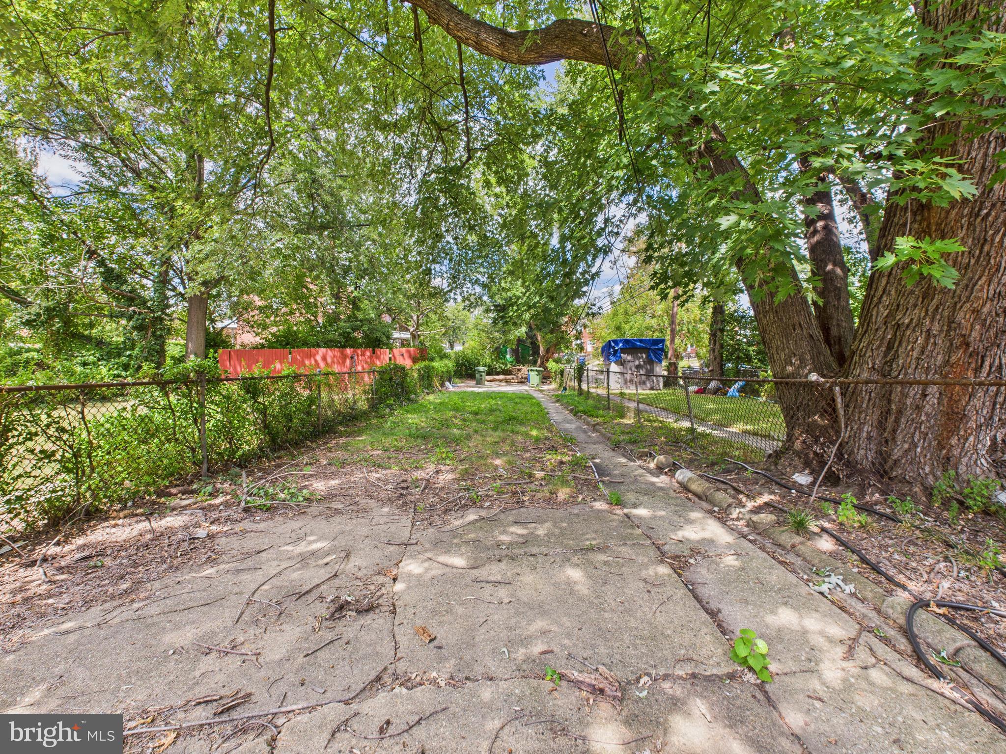 1206 Cedarcroft Road Baltimore, MD 21239 - Photo 24 of 29 a view of a street with a tree