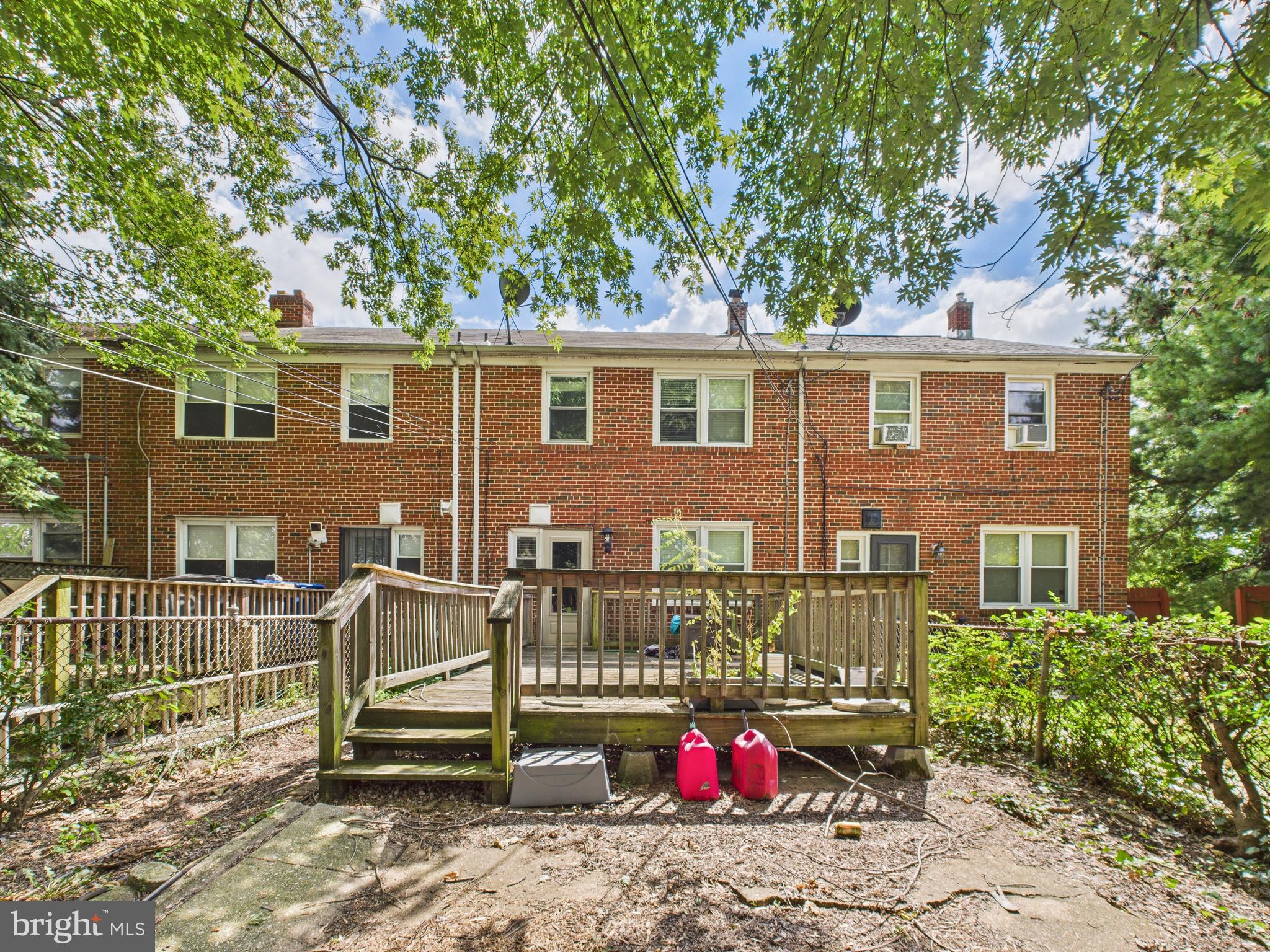 1206 Cedarcroft Road Baltimore, MD 21239 - Photo 25 of 29 a view of a house with a backyard and a tree