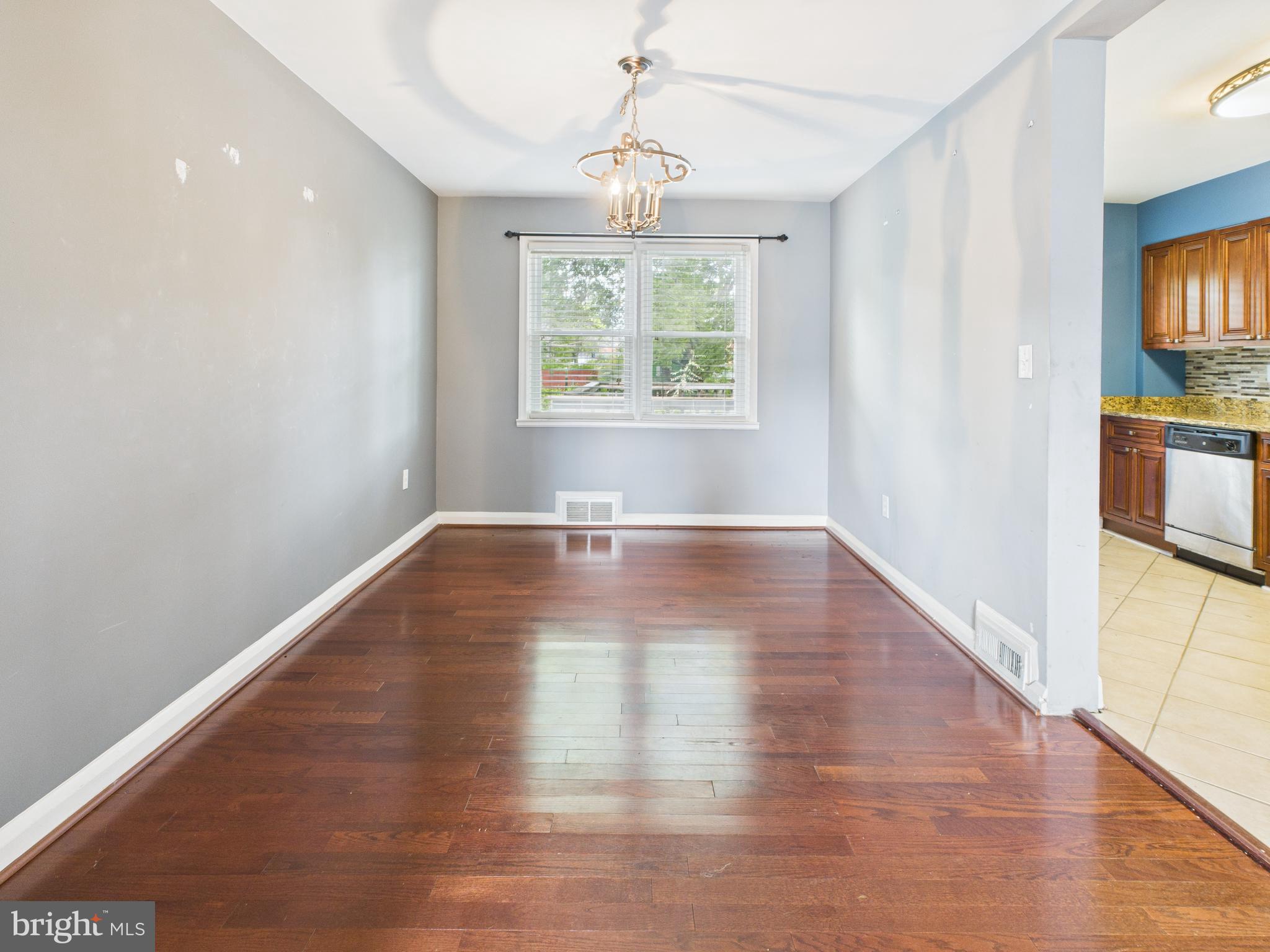1206 Cedarcroft Road Baltimore, MD 21239 - Photo 6 of 29 a view of empty room with wooden floor and fan