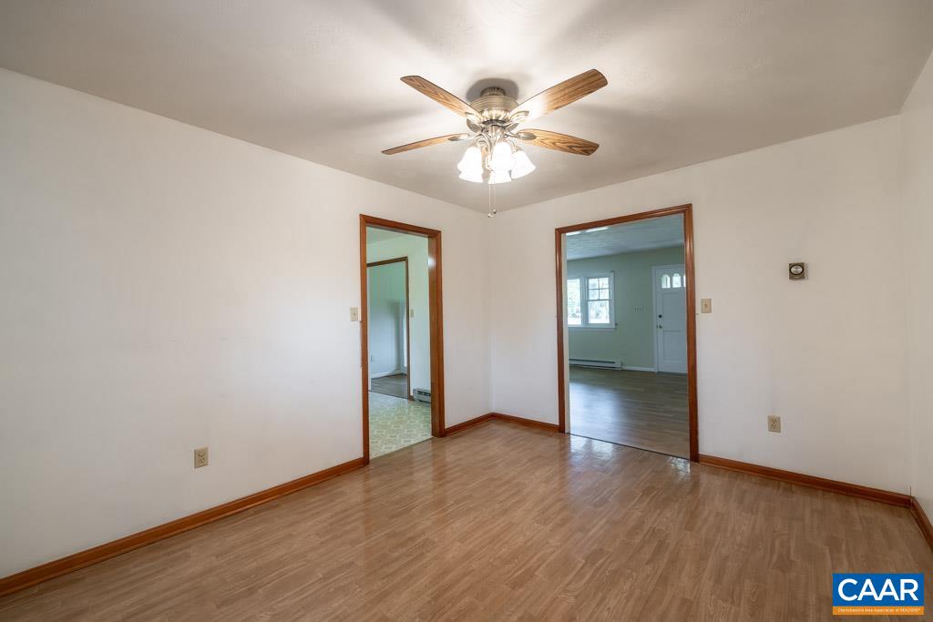 144 Dairy Road Ruckersville, VA 22968 - Photo 17 of 33 a view of an empty room with wooden floor and a ceiling fan