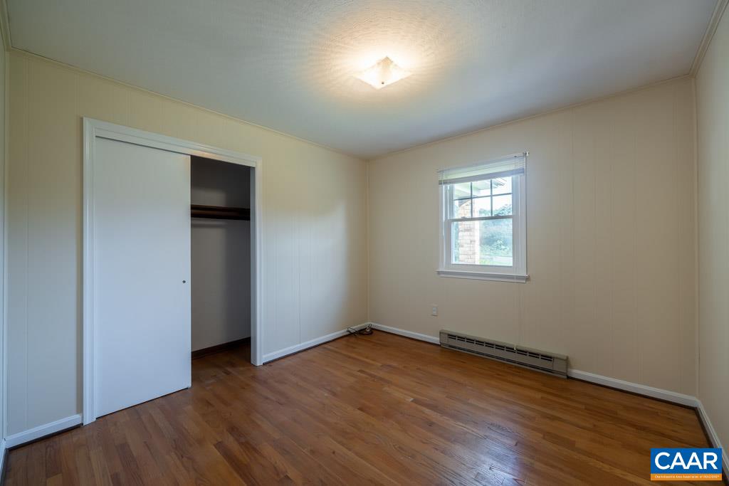 144 Dairy Road Ruckersville, VA 22968 - Photo 18 of 33 an empty room with wooden floor and windows