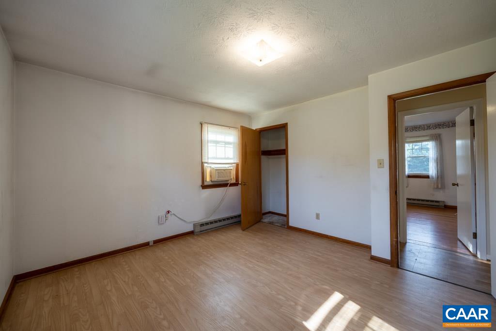 144 Dairy Road Ruckersville, VA 22968 - Photo 21 of 33 an empty room with wooden floor and windows