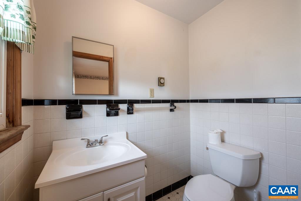 144 Dairy Road Ruckersville, VA 22968 - Photo 24 of 33 a bathroom with a toilet a sink and mirror