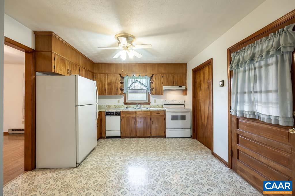144 Dairy Road Ruckersville, VA 22968 - Photo 29 of 33 a kitchen with refrigerator cabinets and wooden floor