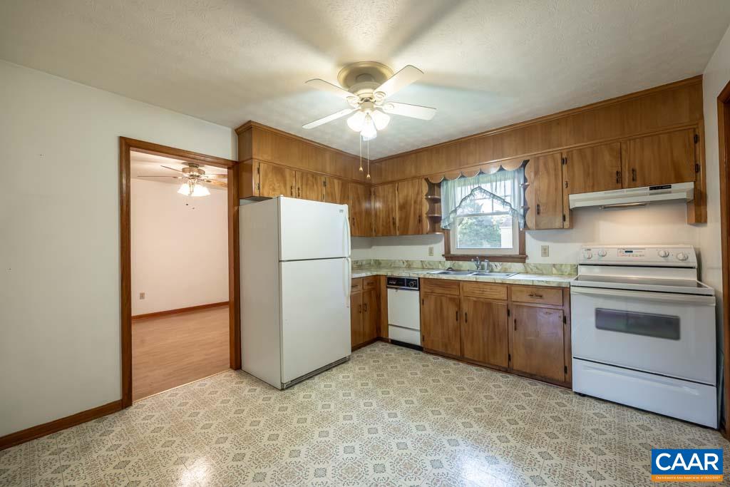144 Dairy Road Ruckersville, VA 22968 - Photo 30 of 33 a kitchen with refrigerator a sink and cabinets