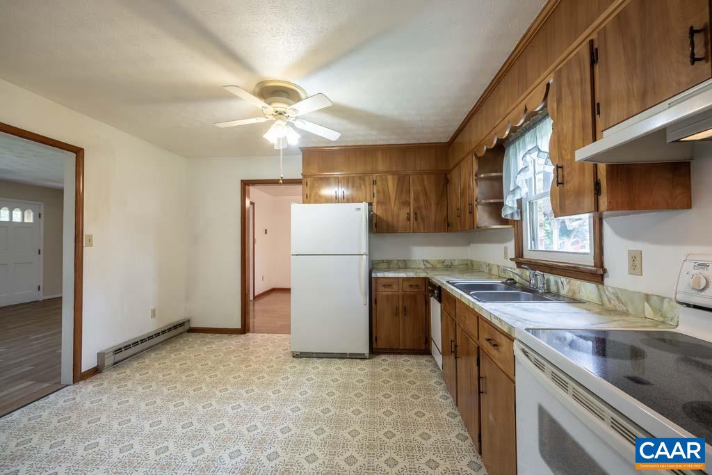 144 Dairy Road Ruckersville, VA 22968 - Photo 31 of 33 a kitchen with a sink a refrigerator and a stove