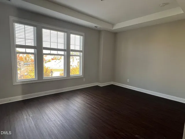 a bathroom with a granite countertop double vanity sink and mirror