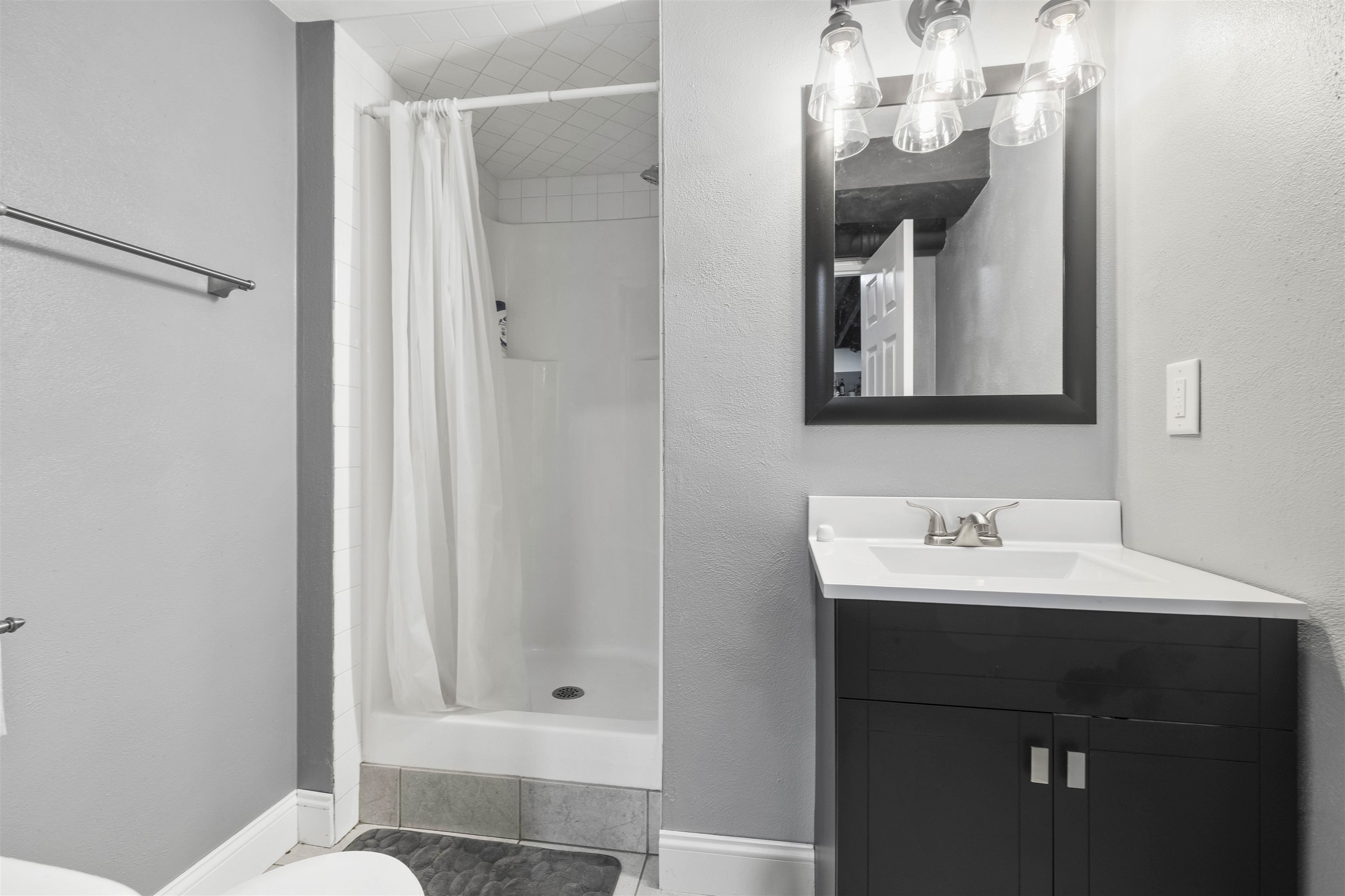 4711 Brookview Road Rockford, IL 61107 - Photo 18 of 26 a bathroom with a sink a mirror and a shower