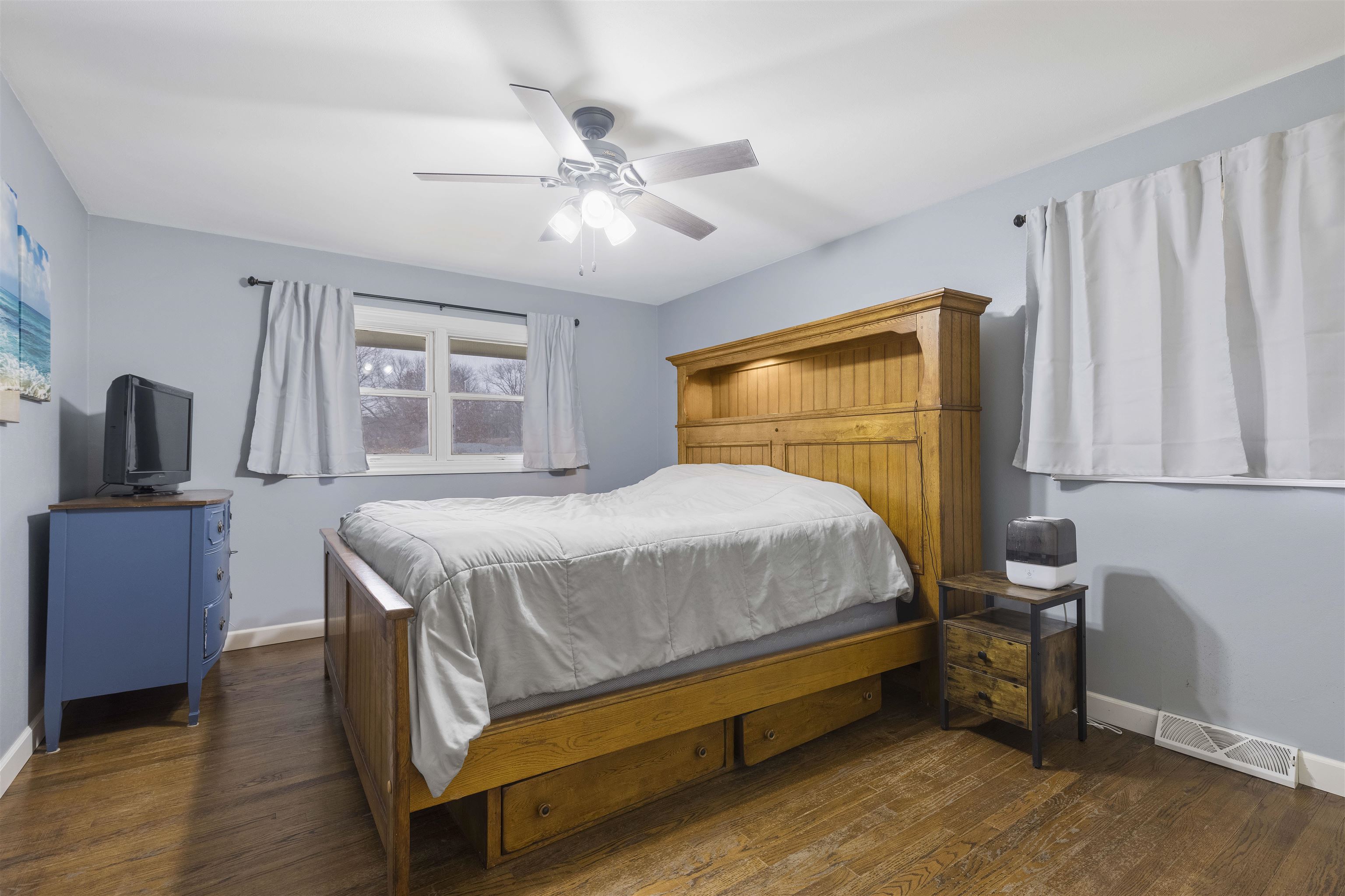 4711 Brookview Road Rockford, IL 61107 - Photo 10 of 26 a bedroom with a bed a dresser next to a window
